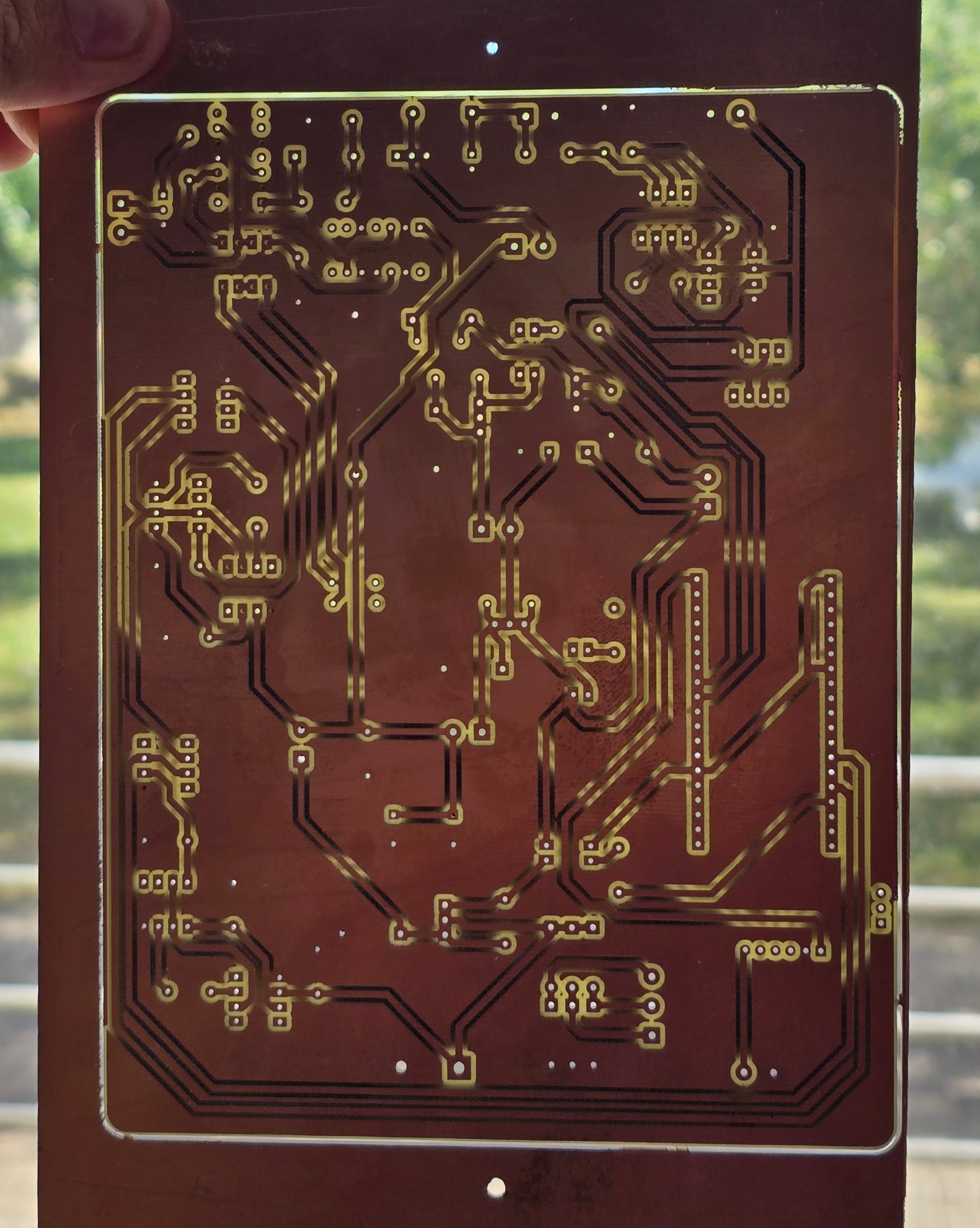 Milled double-sided PCB, back copper, held to the light